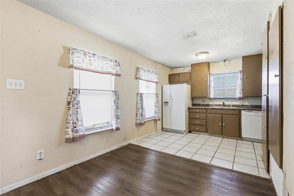 3822 Ragged Rock Court Joshua, TX 76058 - Photo 3 of 34 a kitchen with granite countertop a refrigerator and a stove top oven