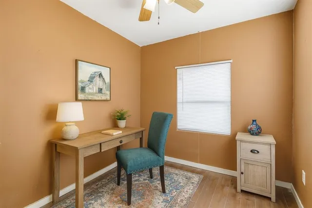 a workspace room with furniture and wooden floor