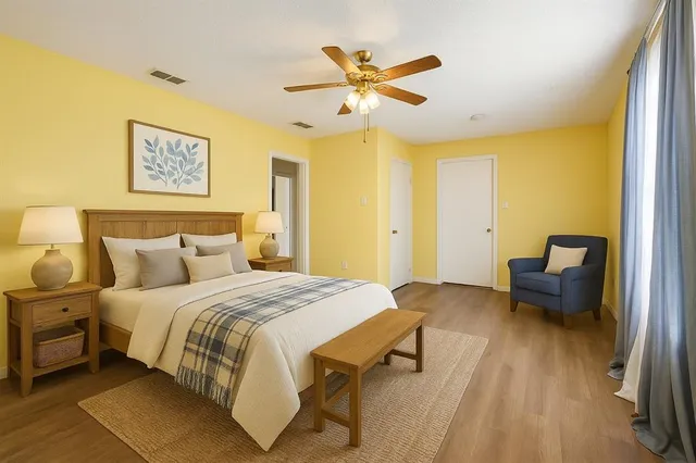 a bedroom with a bed and wooden floor