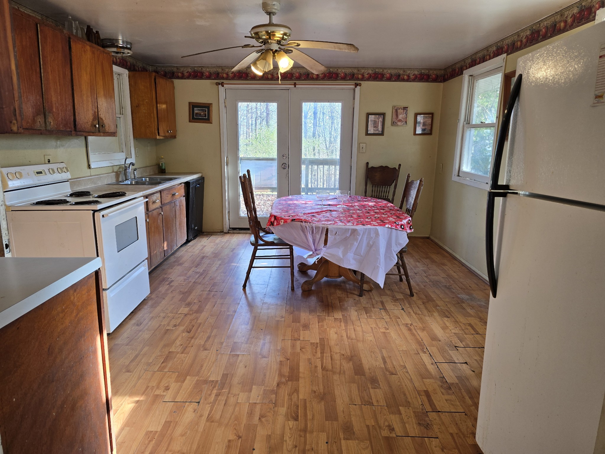 601 Anglin Ridge Road Dover, TN 37058 - Photo 4 of 29 a dining room with furniture a rug a refrigerator and wooden floor