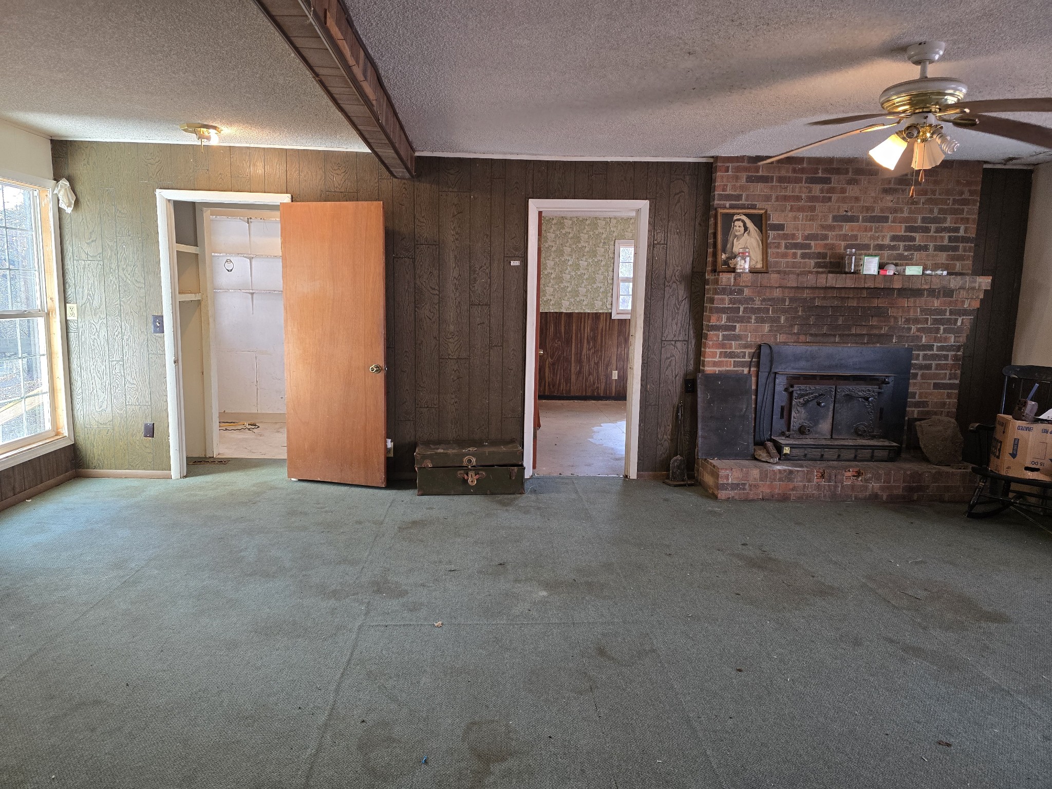 601 Anglin Ridge Road Dover, TN 37058 - Photo 6 of 30 an empty room with fireplace and fan