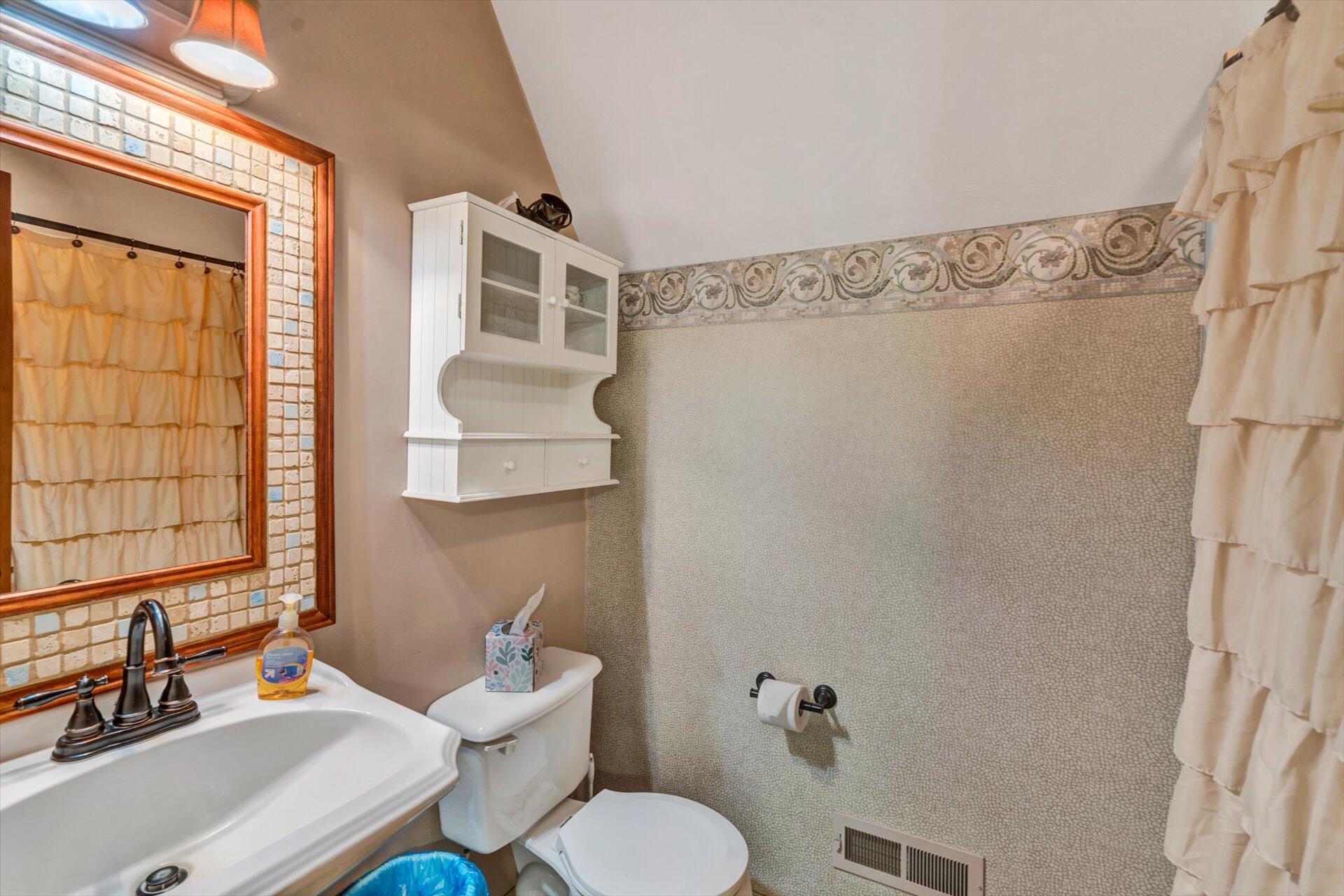 2339 Navigation Point Goodview, VA 24095 - Photo 26 of 49 a bathroom with a sink mirror and a toilet