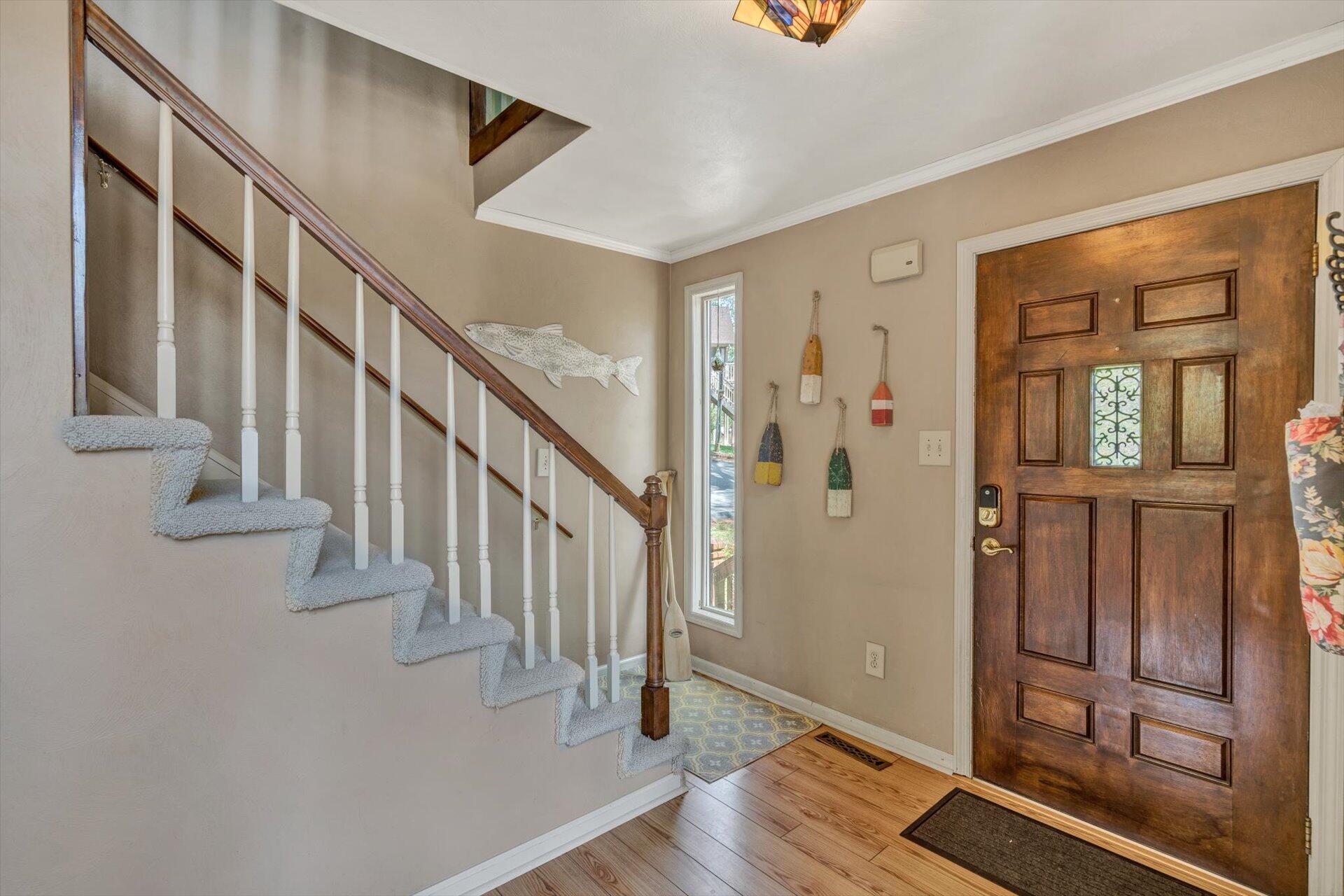 2339 Navigation Point Goodview, VA 24095 - Photo 9 of 49 a view of an entryway with wooden floor and stairs