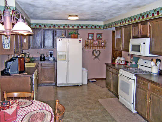58 North Maryland Road Polo, IL 61064 - Photo 5 of 6 a kitchen with stainless steel appliances granite countertop a refrigerator and a stove top oven