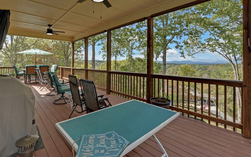 280 Cherokee Court Ellijay, GA 30540 - Photo 25 of 73 a view of a balcony with chairs and wooden floor