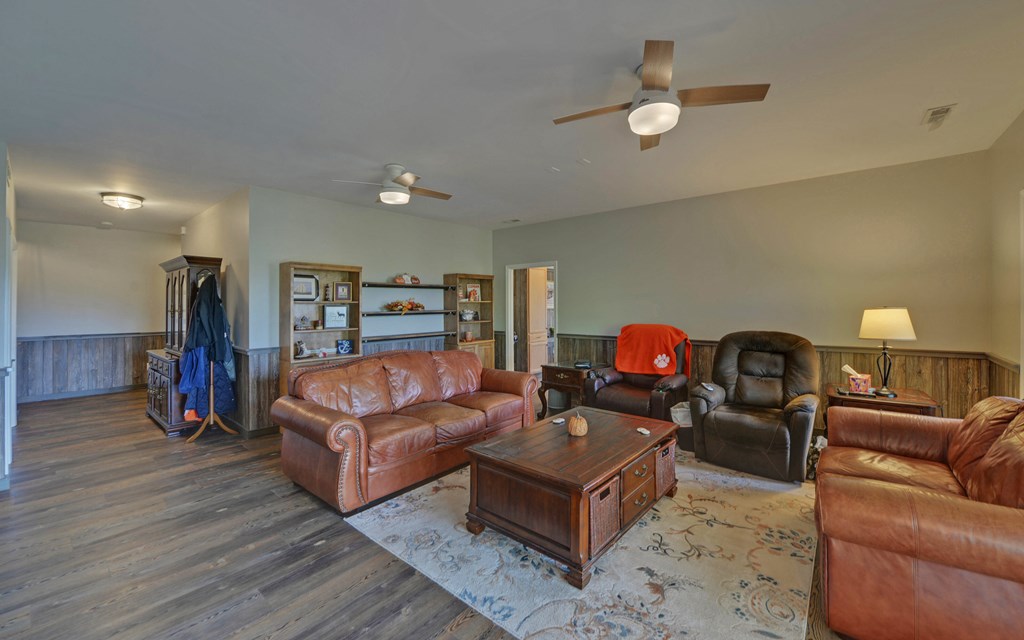 280 Cherokee Court Ellijay, GA 30540 - Photo 32 of 73 a living room with couches a coffee table and a lamp with wooden floor