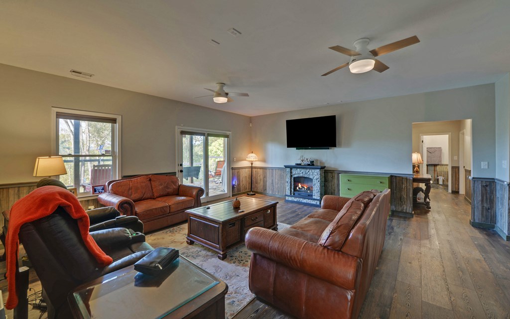 280 Cherokee Court Ellijay, GA 30540 - Photo 33 of 73 a living room with furniture a fireplace and a flat screen tv