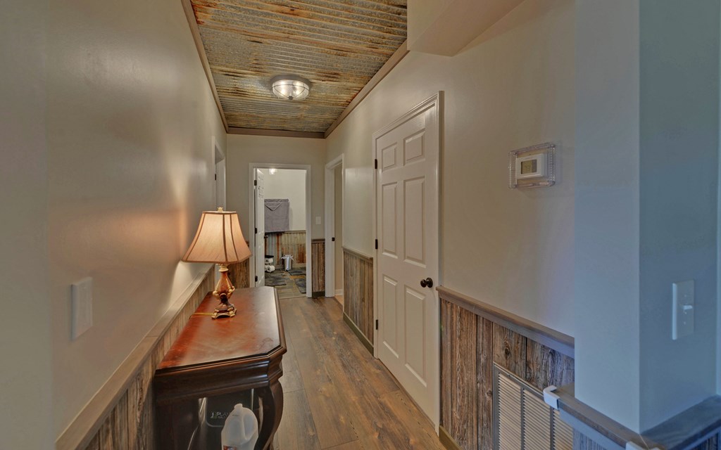 280 Cherokee Court Ellijay, GA 30540 - Photo 41 of 73 a view of a hallway with workspace and wooden floor