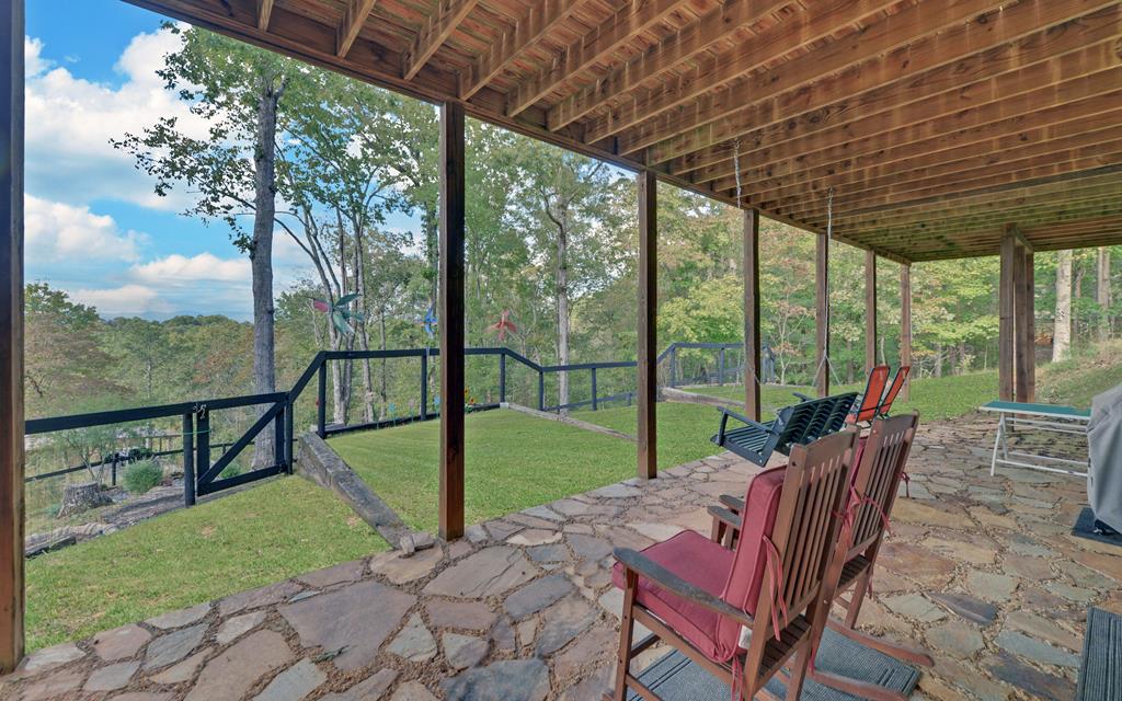 280 Cherokee Court Ellijay, GA 30540 - Photo 48 of 73 a view of a patio with a table chairs and a backyard