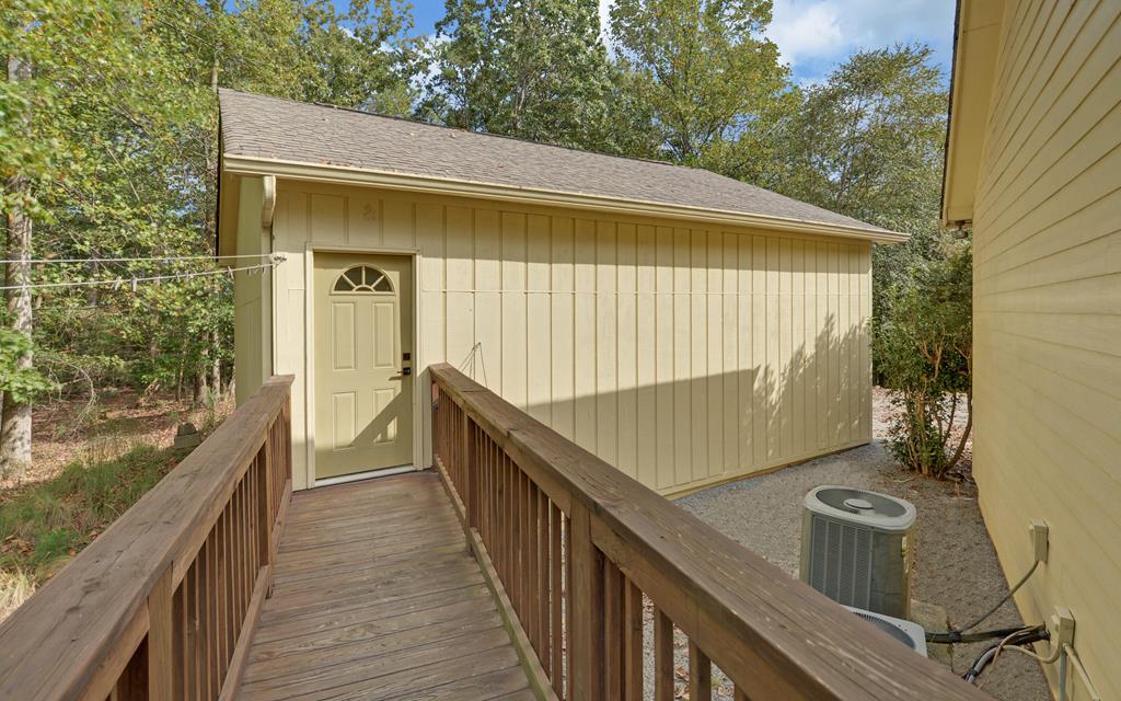 280 Cherokee Court Ellijay, GA 30540 - Photo 54 of 73 a view of a balcony with wooden floor and iron stairs