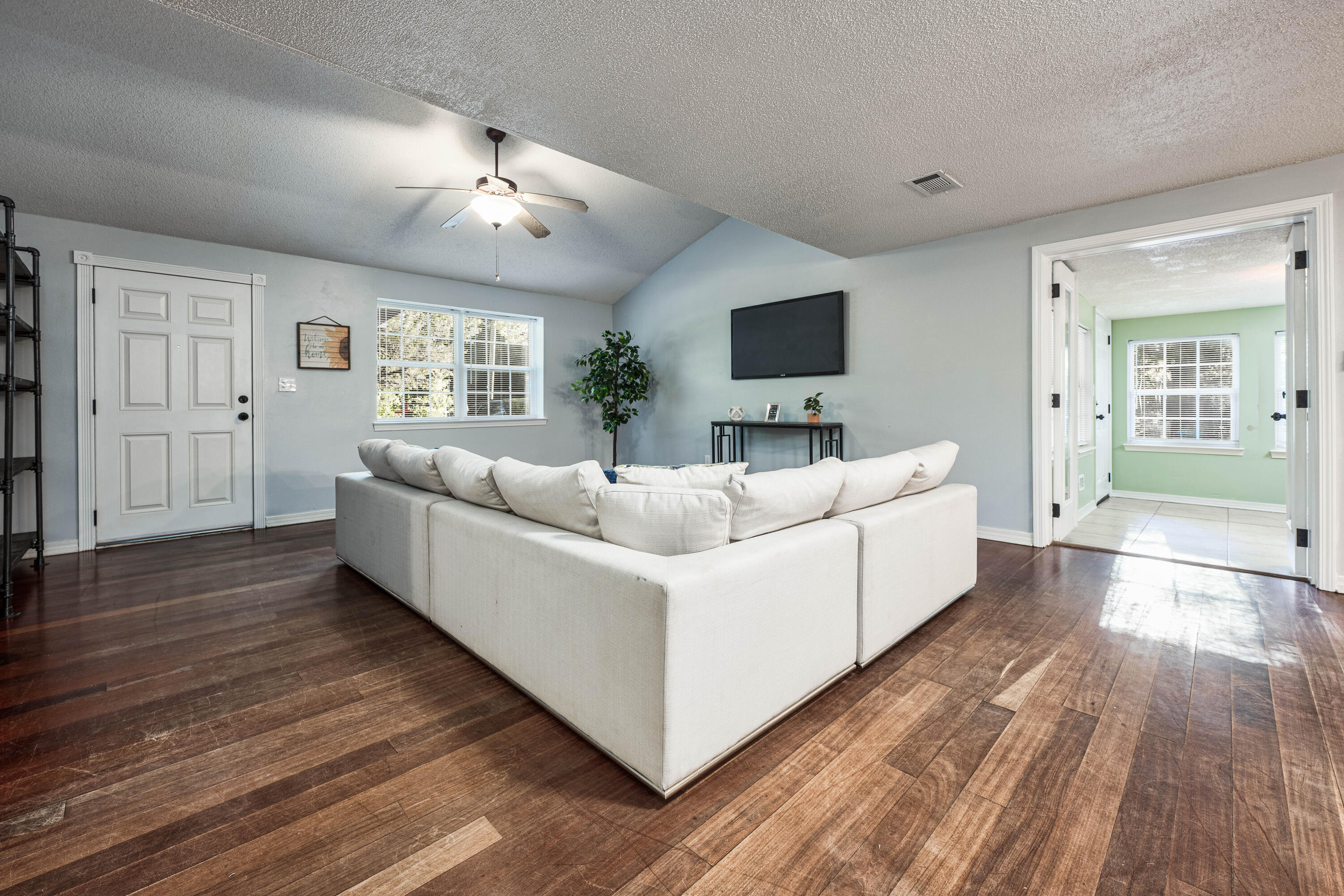 1838 Wadsworth Road Baker, FL 32531 - Photo 15 of 71 a living room with furniture and a flat screen tv