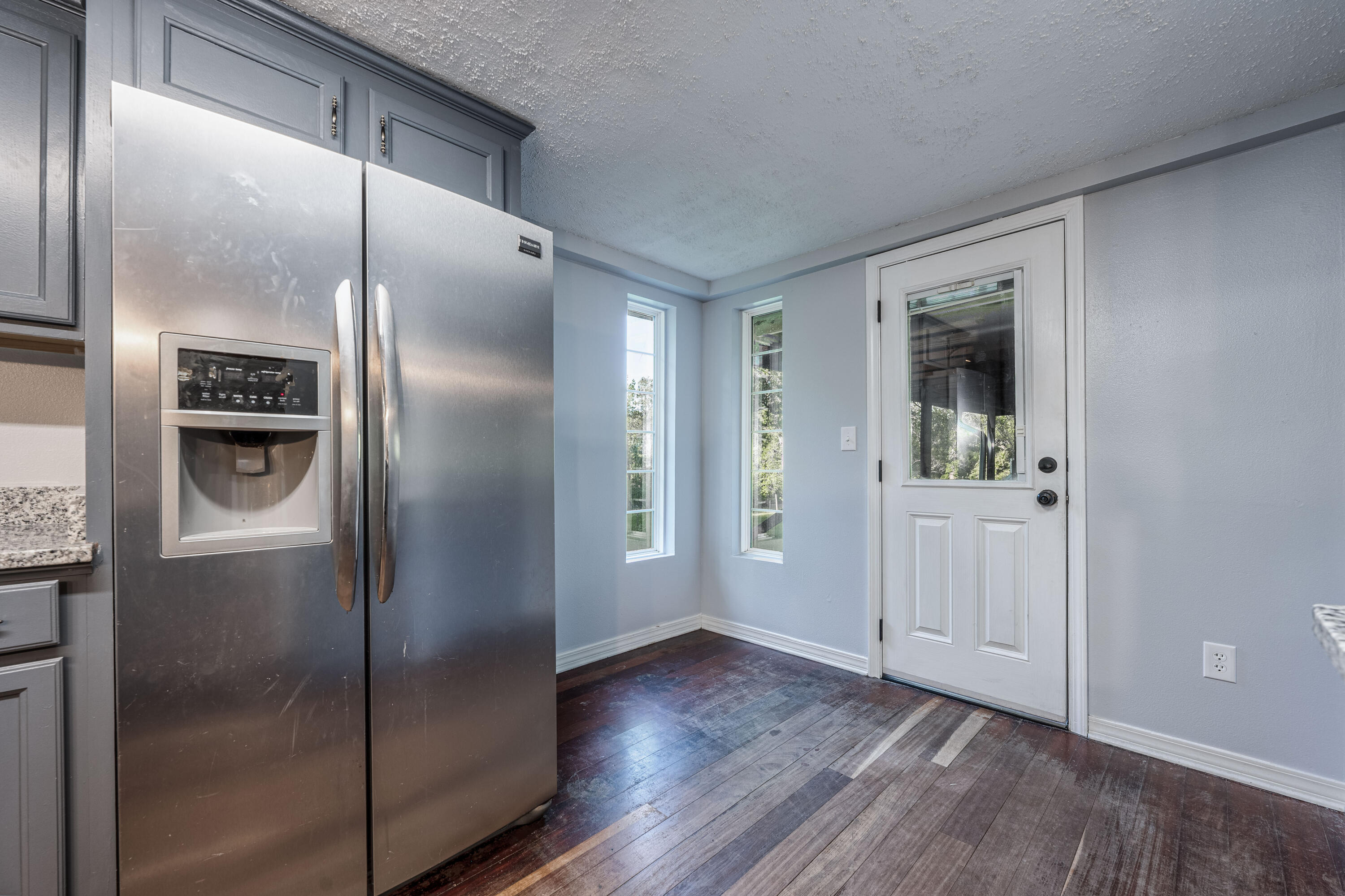 1838 Wadsworth Road Baker, FL 32531 - Photo 26 of 71 a kitchen with a refrigerator and wooden floor
