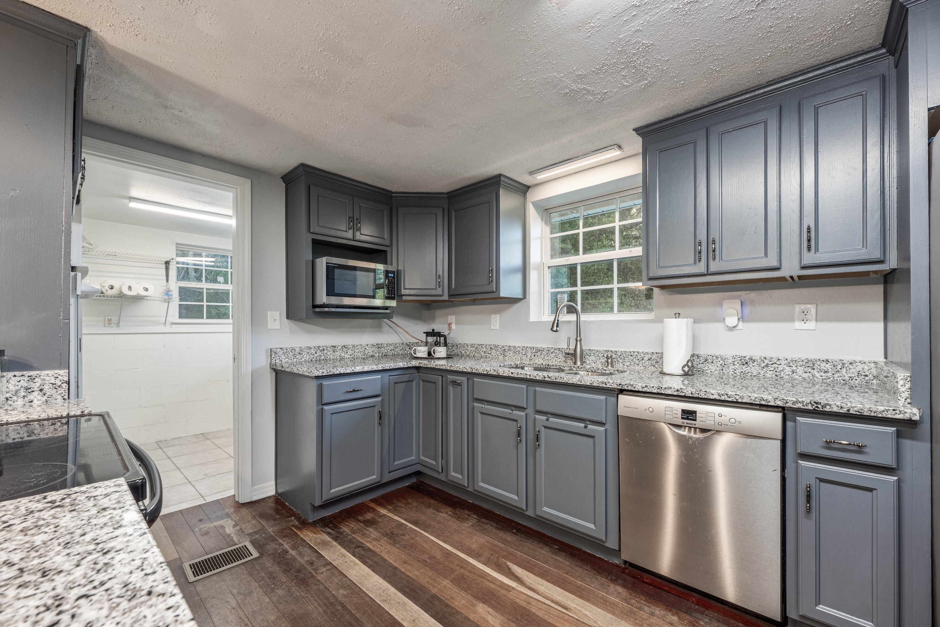 1838 Wadsworth Road Baker, FL 32531 - Photo 4 of 71 a kitchen with granite countertop stainless steel appliances a stove sink and microwave