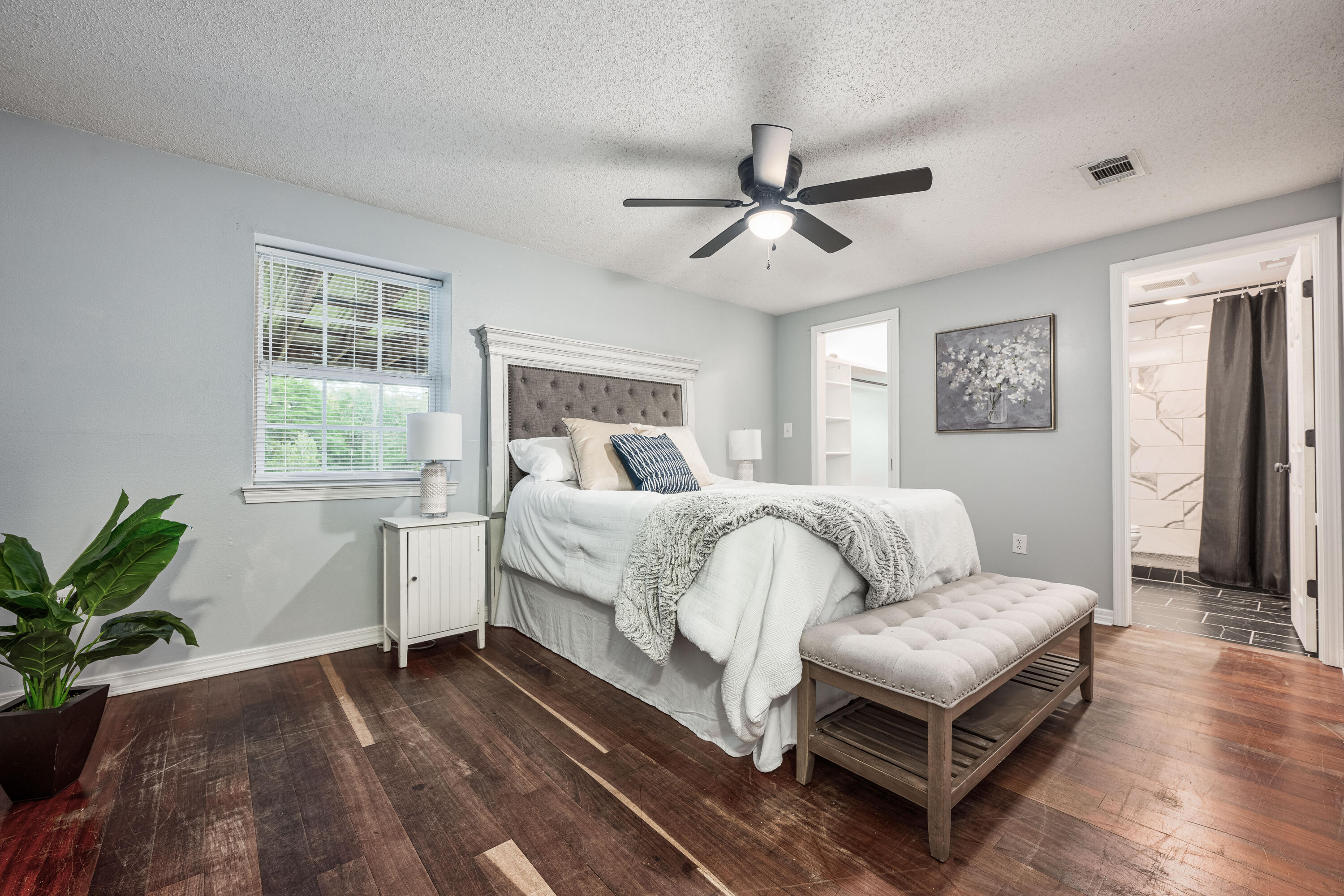 1838 Wadsworth Road Baker, FL 32531 - Photo 5 of 71 a bedroom with a bed a couch and a potted plant