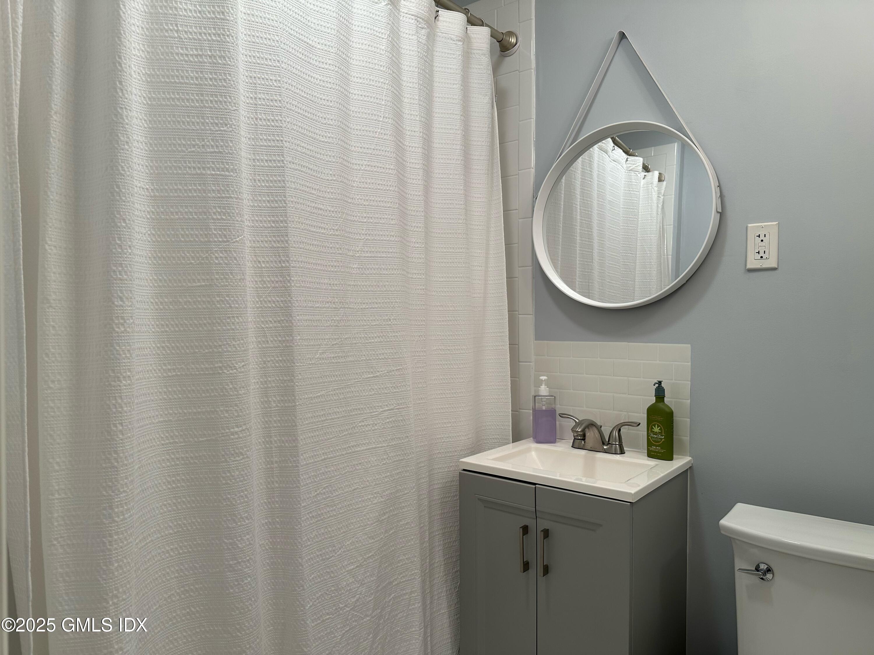 37 Gerry Street, Unit 1 Greenwich, CT 06830 - Photo 12 of 19 a bathroom with a sink and mirror