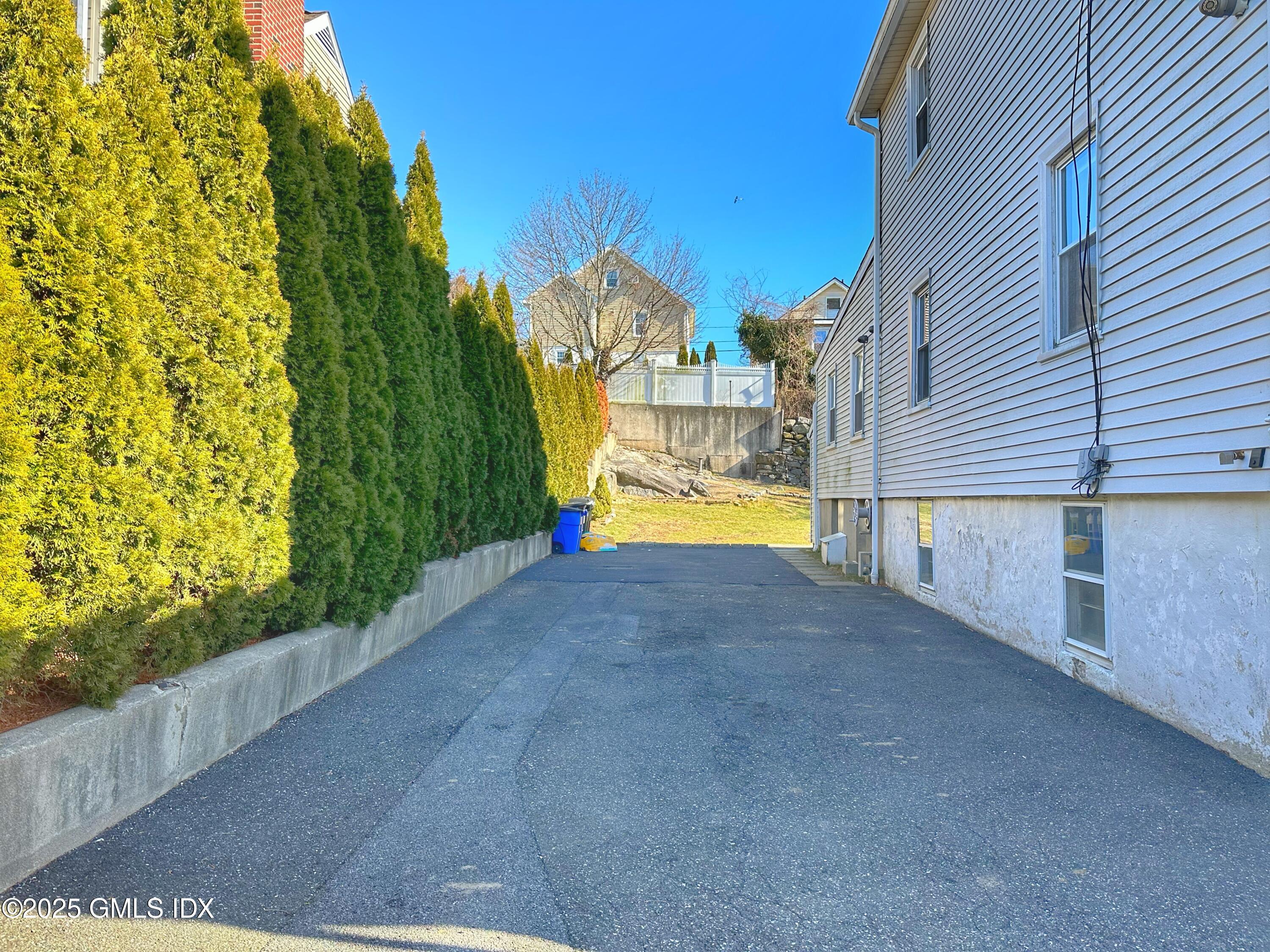 37 Gerry Street, Unit 1 Greenwich, CT 06830 - Photo 16 of 19 a view of a house with a yard and a garage