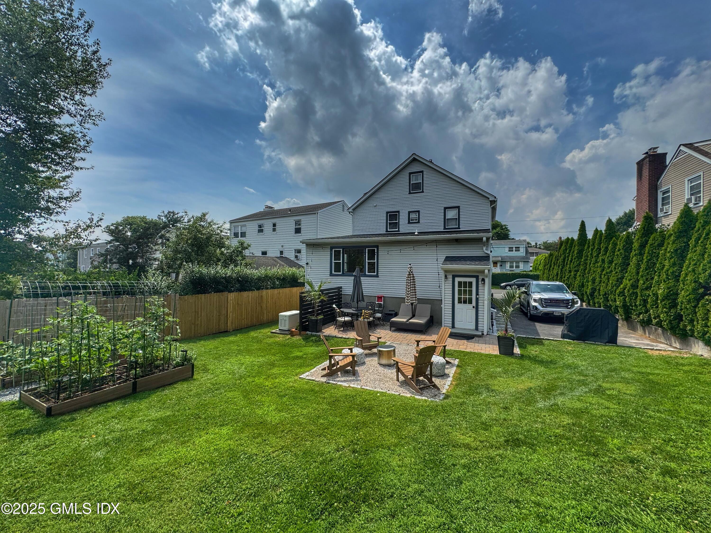 37 Gerry Street, Unit 1 Greenwich, CT 06830 - Photo 17 of 19 a view of a house with backyard porch and sitting area