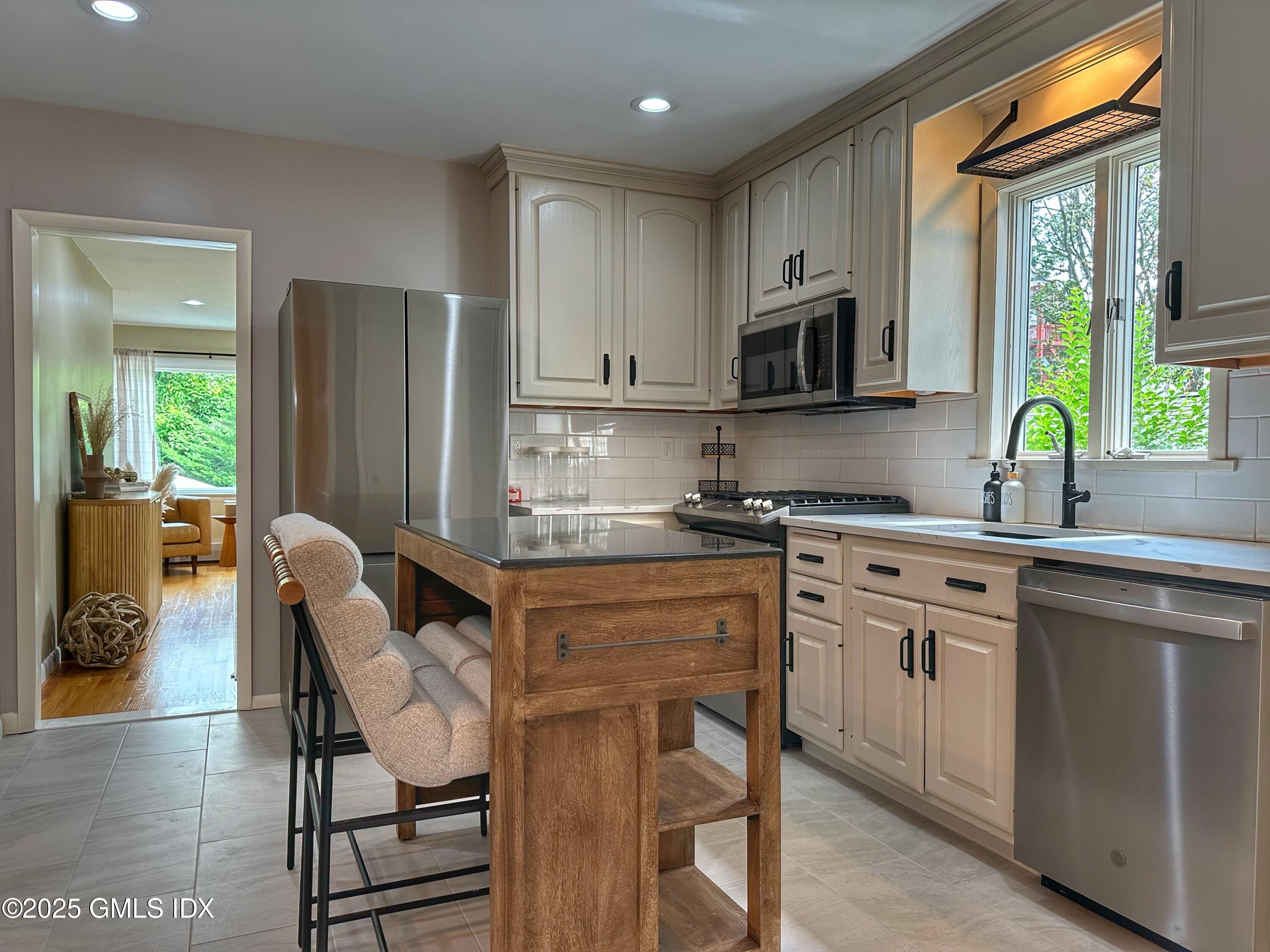37 Gerry Street, Unit 1 Greenwich, CT 06830 - Photo 2 of 19 a kitchen with stainless steel appliances granite countertop a stove a sink island and a refrigerator