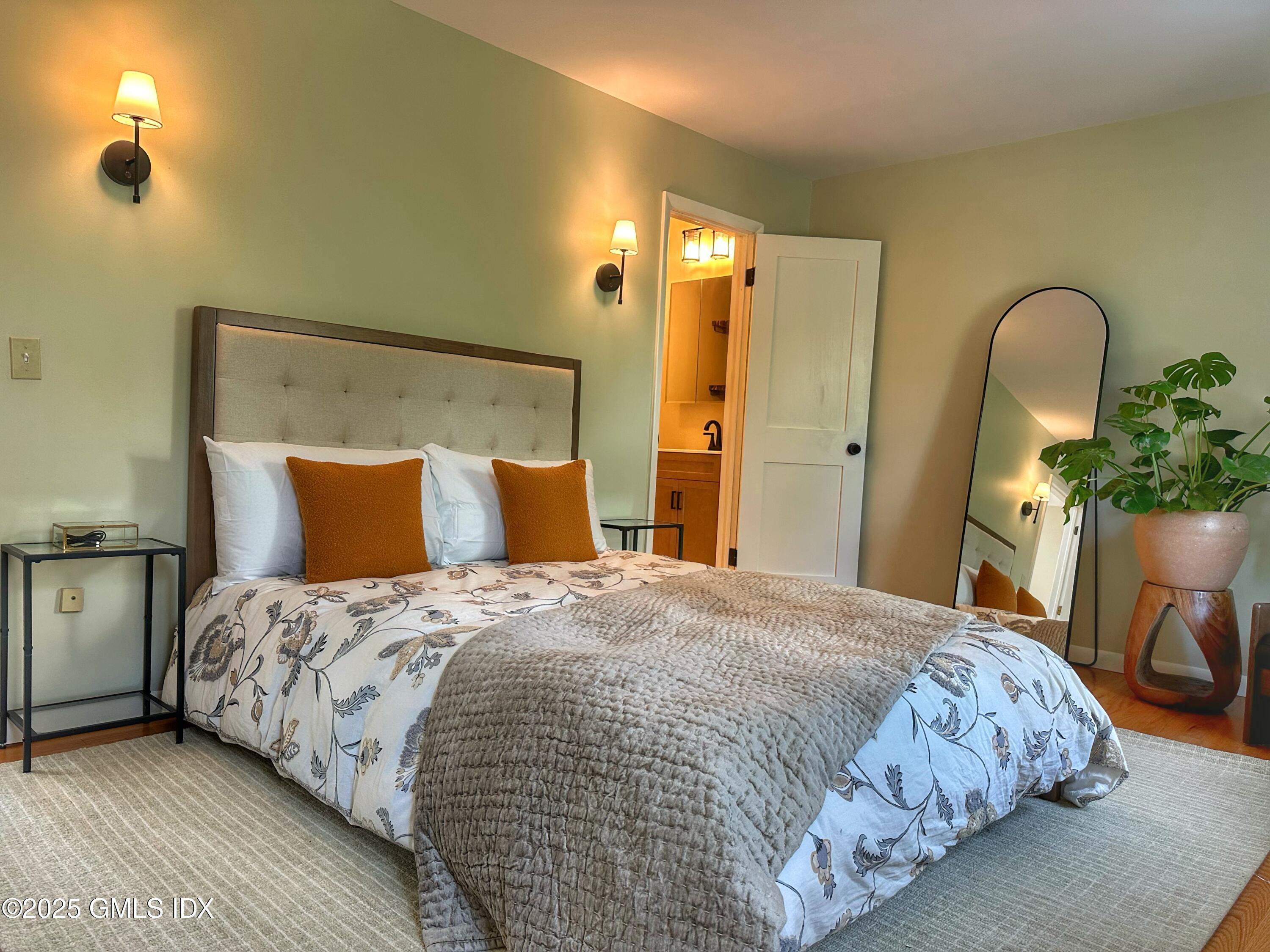 37 Gerry Street, Unit 1 Greenwich, CT 06830 - Photo 4 of 19 a bedroom with bed and a potted plant