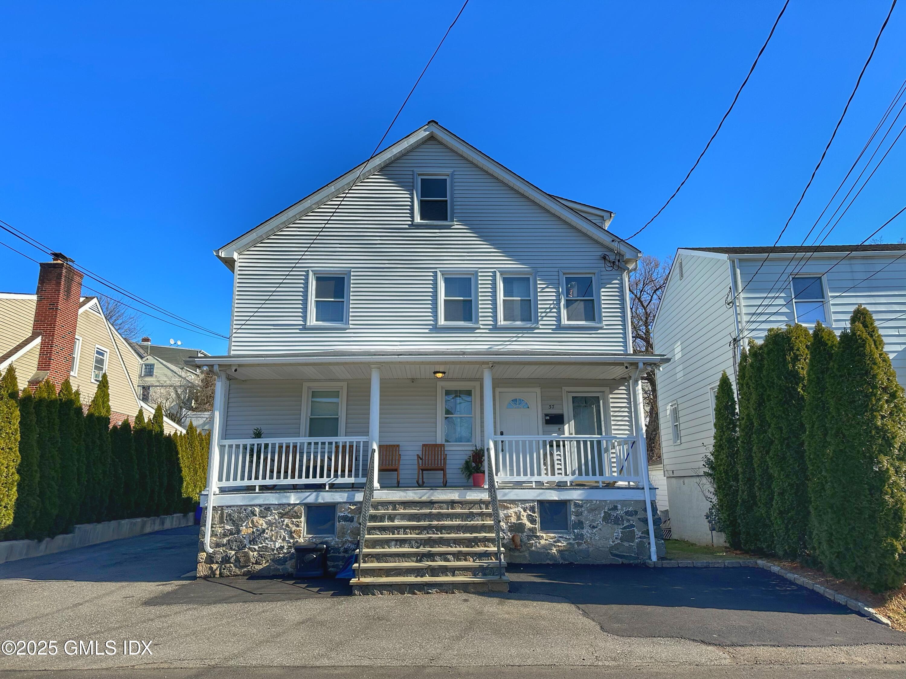 37 Gerry Street, Unit 1 Greenwich, CT 06830 - Photo 7 of 19 a front view of a house with a garden
