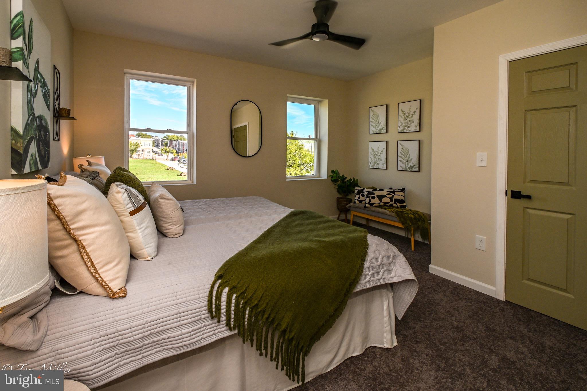 1743 Federal Street Baltimore, MD 21213 - Photo 14 of 42 a bedroom with a bed and wooden floor