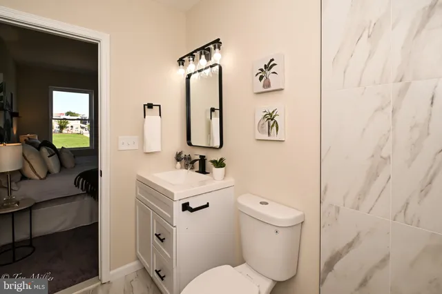 a bathroom with a toilet sink and mirror