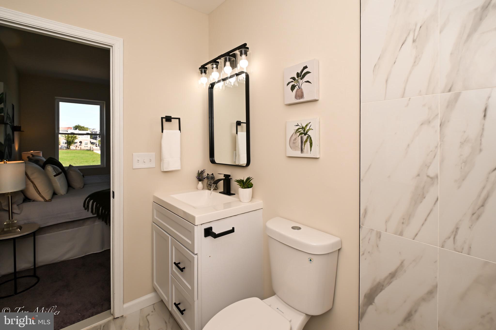 1743 Federal Street Baltimore, MD 21213 - Photo 17 of 42 a bathroom with a toilet sink and mirror