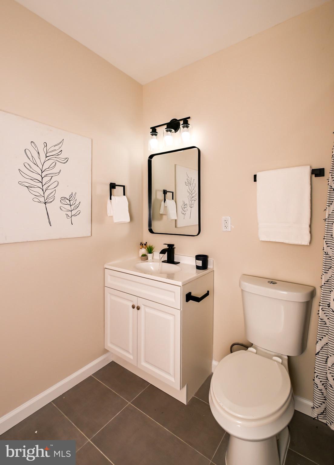 1743 Federal Street Baltimore, MD 21213 - Photo 18 of 42 a bathroom with a toilet sink and mirror