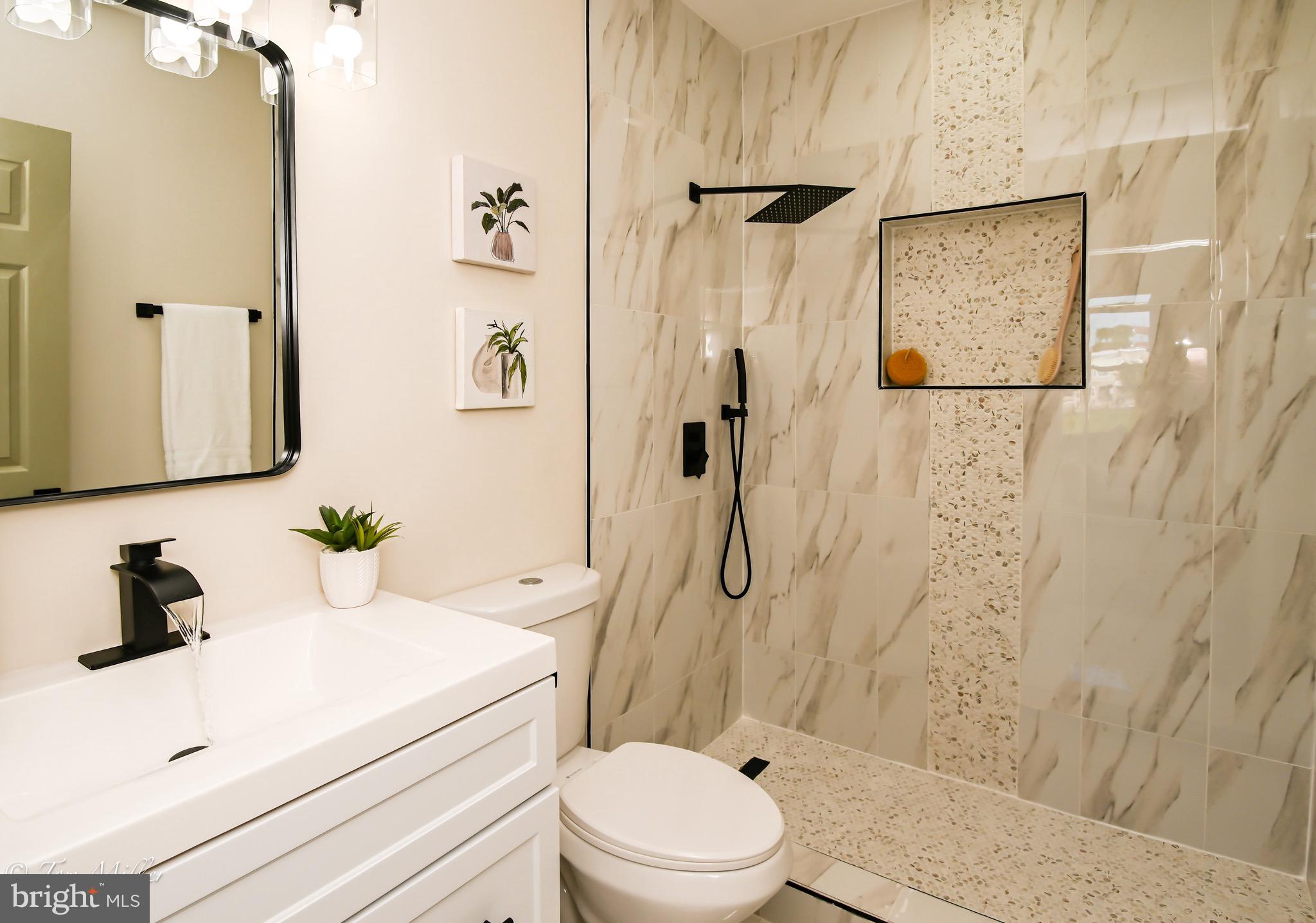 1743 Federal Street Baltimore, MD 21213 - Photo 19 of 42 a bathroom with a sink toilet and shower