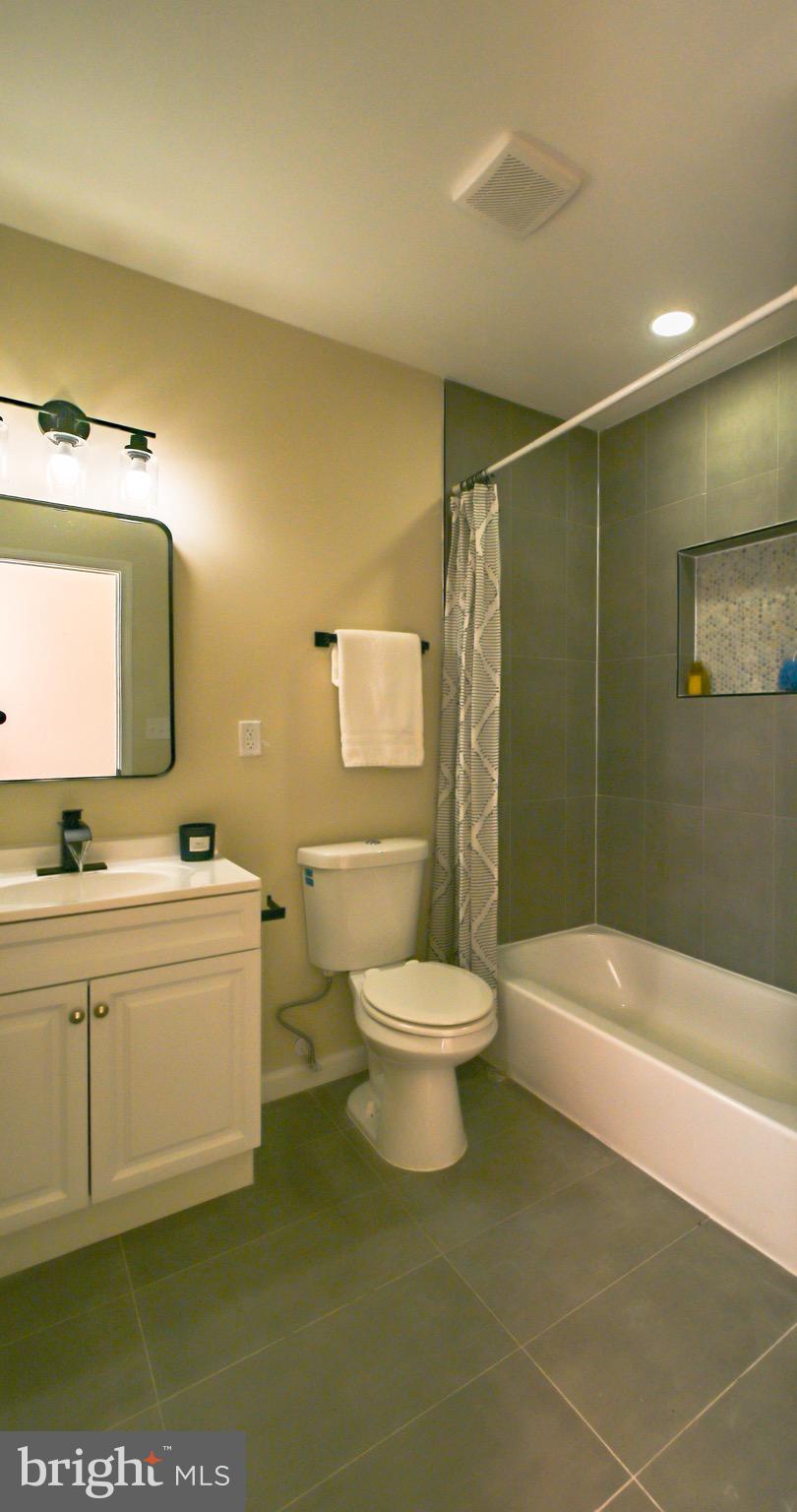 1743 Federal Street Baltimore, MD 21213 - Photo 24 of 42 a bathroom with a toilet a sink and bathtub