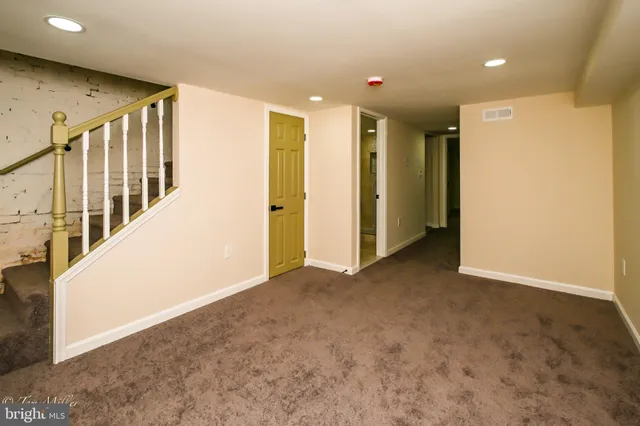 a view of a hallway with closet and cabinet