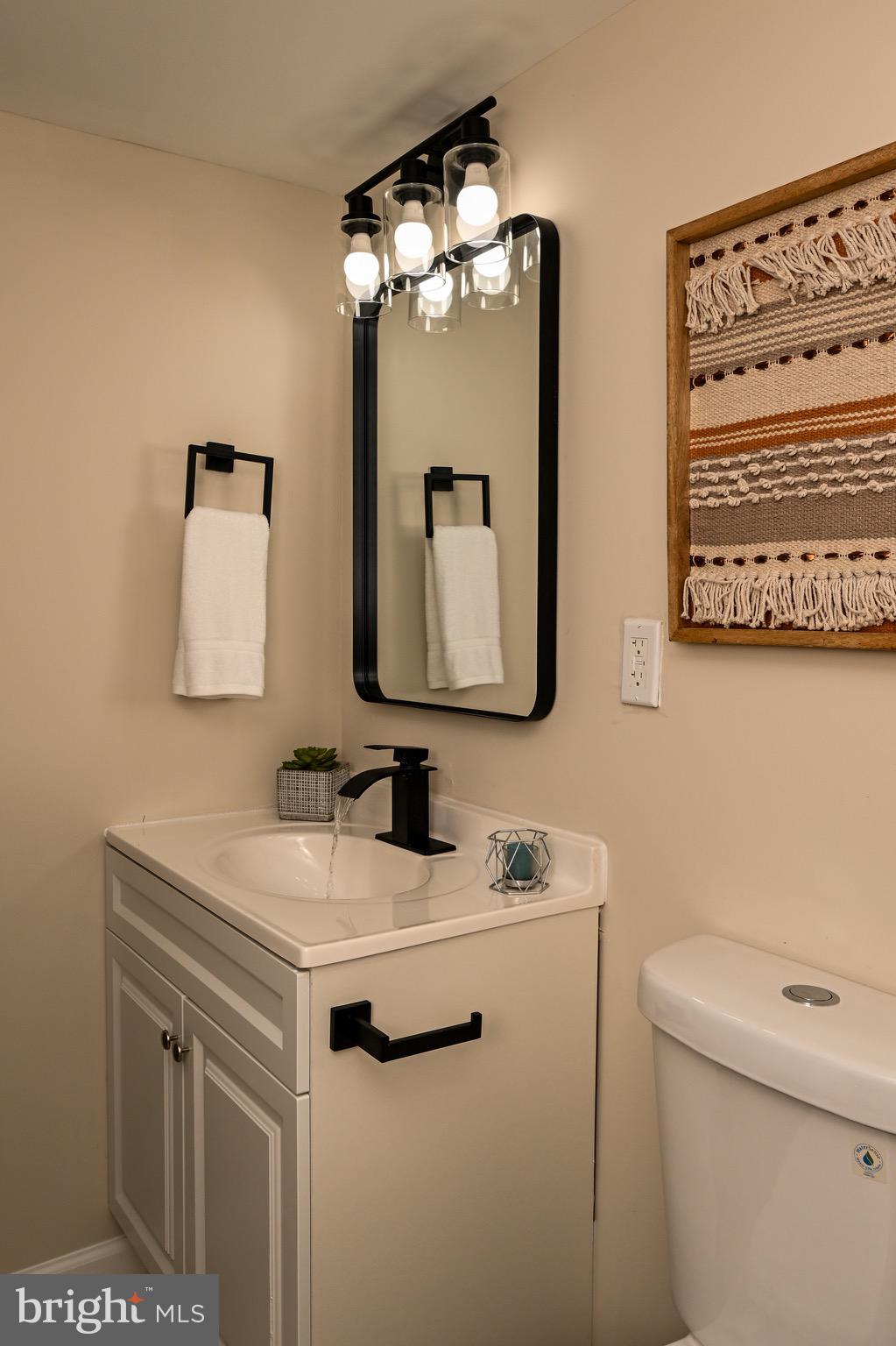 1743 Federal Street Baltimore, MD 21213 - Photo 31 of 42 a bathroom with a sink toilet and mirror