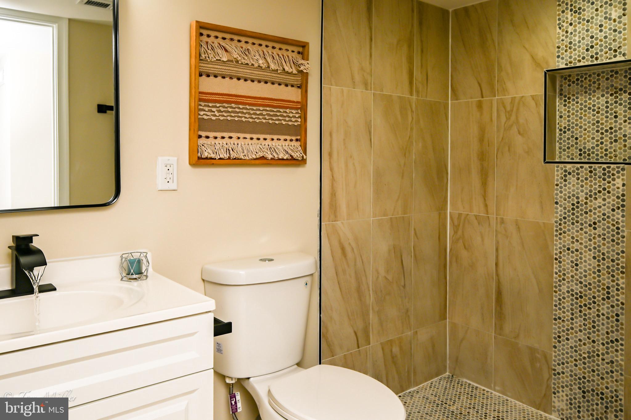 1743 Federal Street Baltimore, MD 21213 - Photo 32 of 42 a bathroom with a toilet sink and shower