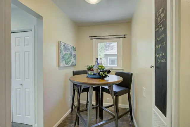 a view of a dining room with furniture and window