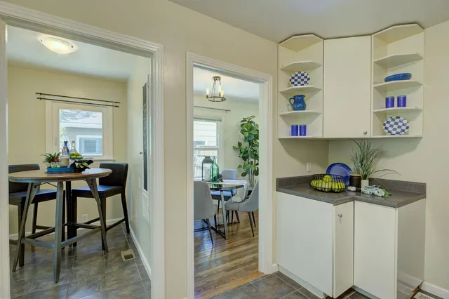 a view of a dining room with furniture and a potted plant