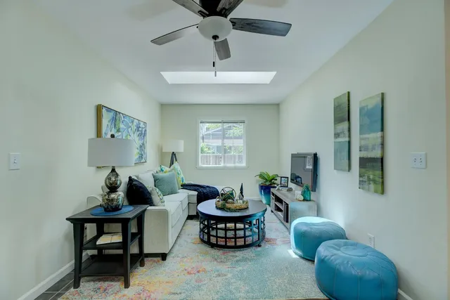a living room with furniture potted plant and a window
