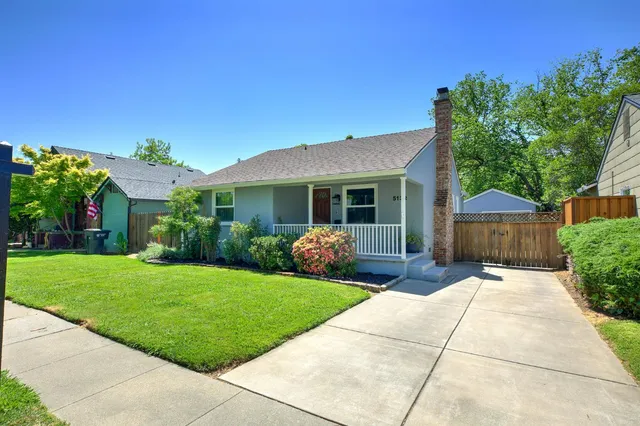 a front view of a house with a garden and yard