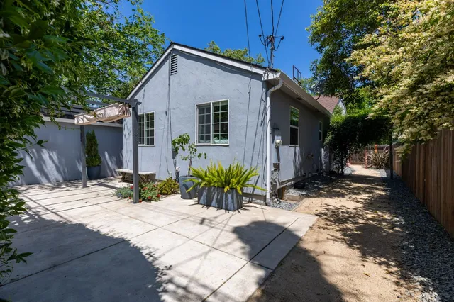 a view of house with yard and sitting area