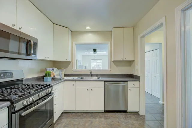 a kitchen with stainless steel appliances granite countertop a stove and a sink