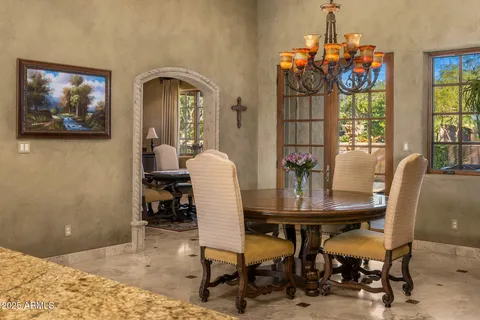a kitchen with a table chairs and a refrigerator