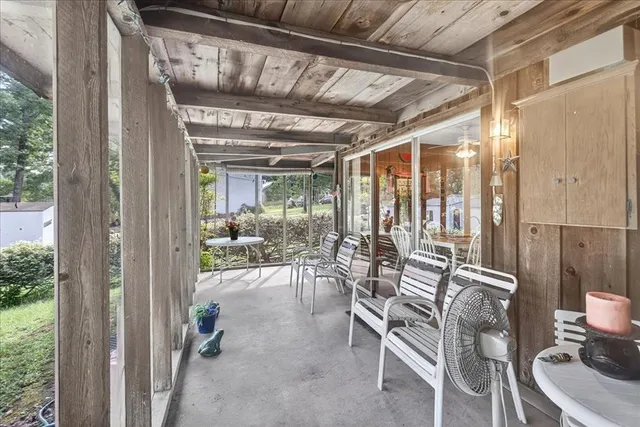 a view of a patio with table and chairs and potted plants