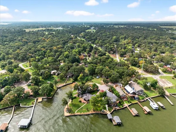 an aerial view of residential houses with outdoor space and street view