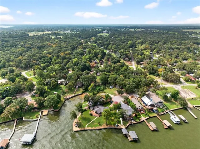 an aerial view of residential houses with outdoor space and street view