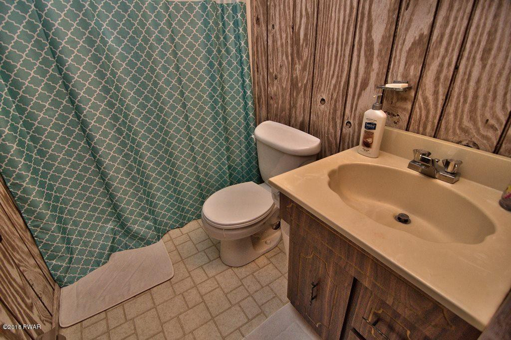 3278 Northgate Road Lake Ariel, PA 18436 - Photo 31 of 40 a bathroom with a toilet sink and mirror