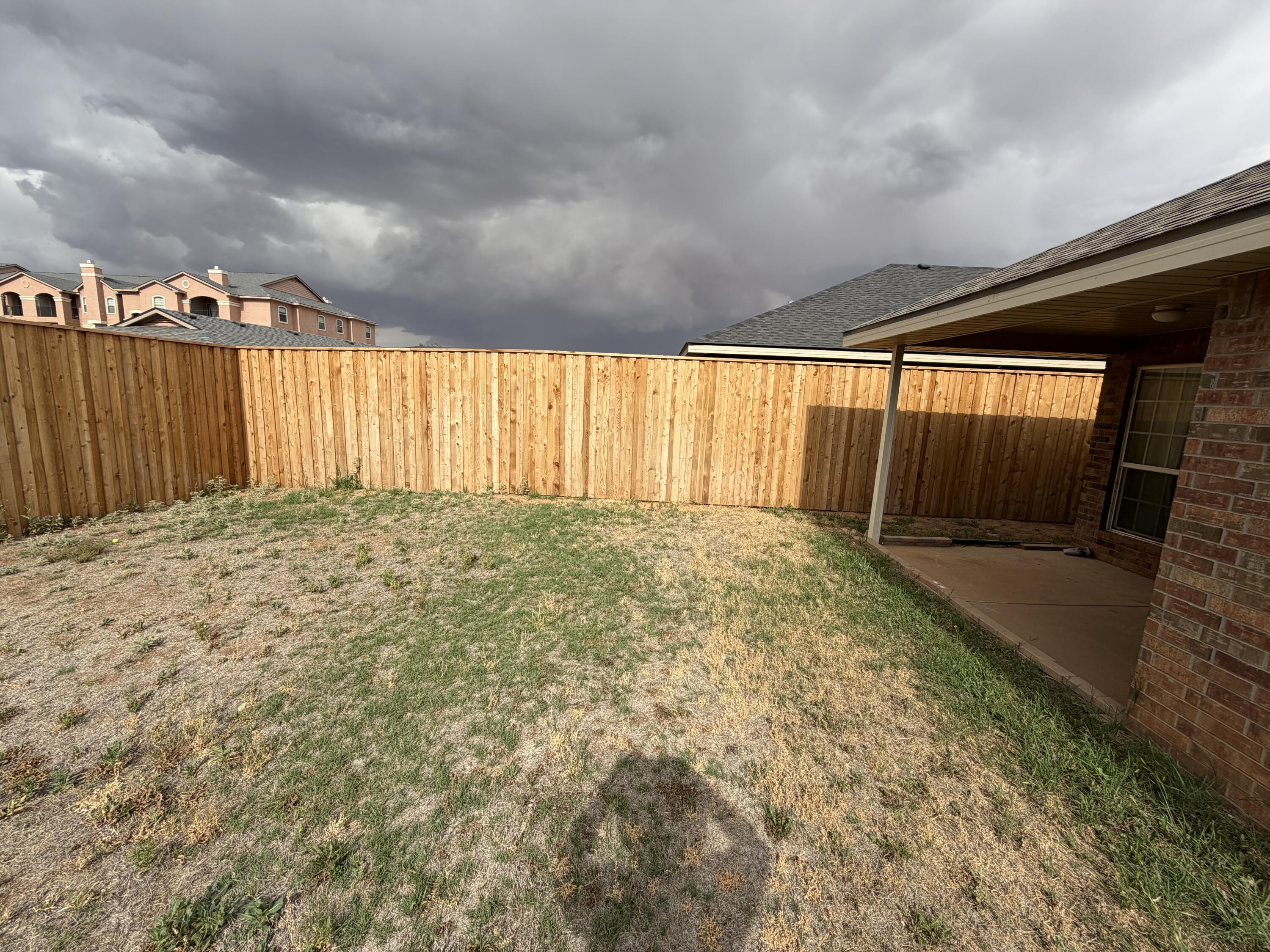 6544 84th Street Lubbock, TX 79424 - Photo 3 of 29 a view of large garden with wooden fence