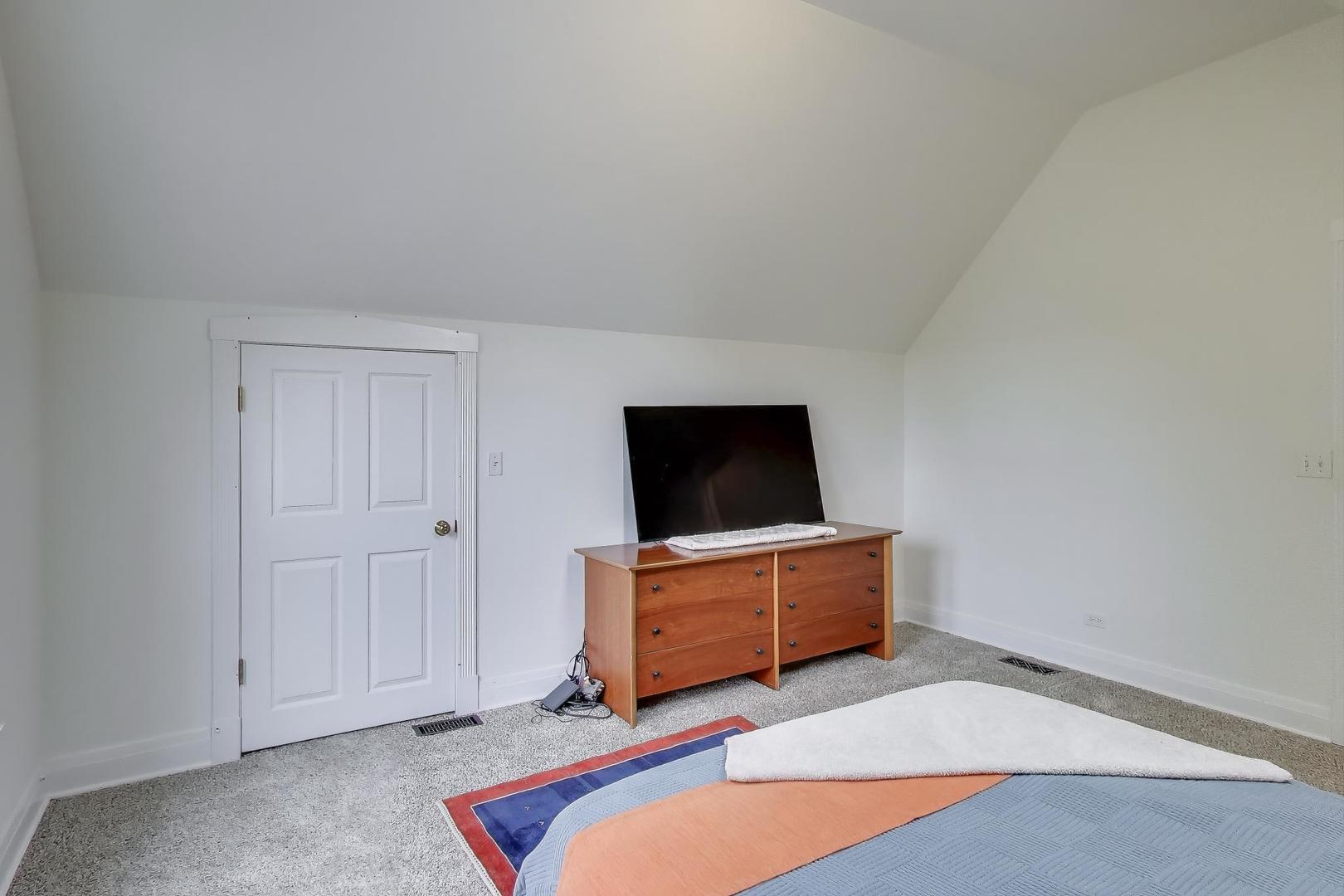 3615 North Hoyne Avenue, Unit 2F Chicago, IL 60618 - Photo 18 of 24 a room with furniture and flat screen tv