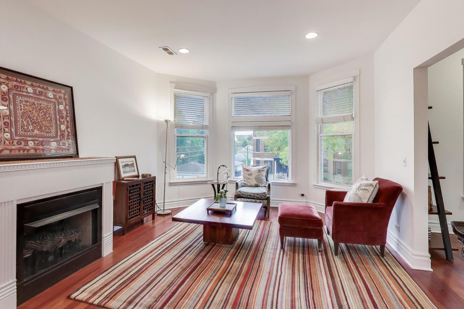 3615 North Hoyne Avenue, Unit 2F Chicago, IL 60618 - Photo 4 of 24 a living room with furniture and a fireplace