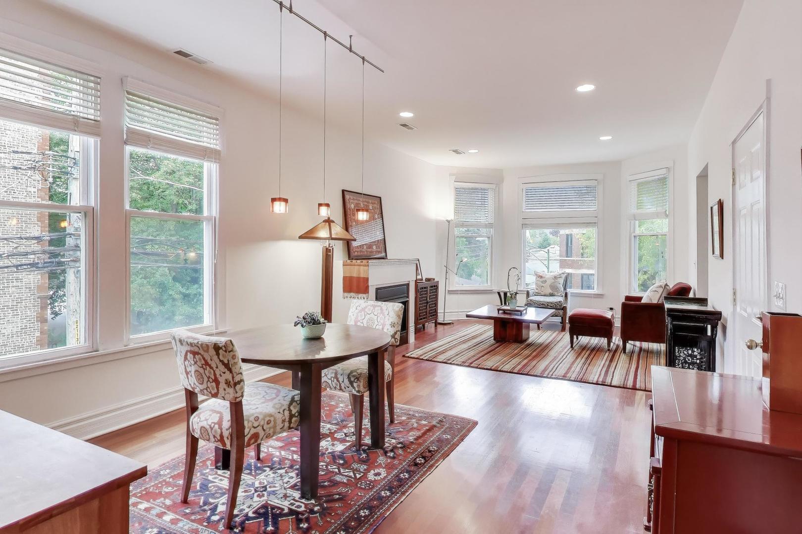 3615 North Hoyne Avenue, Unit 2F Chicago, IL 60618 - Photo 5 of 24 a living room with furniture and a large window
