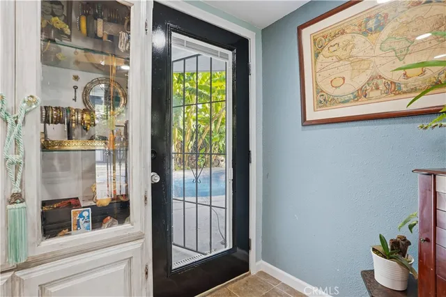 a kitchen with granite countertop white cabinets and window