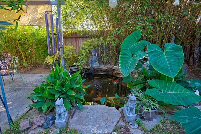 a backyard of a house with lots of green space and plants
